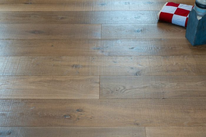 close up of hardwood floor with red and white checkered fabric