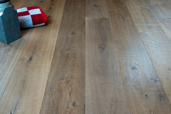 close up of hardwood floor with red and white checkered fabric