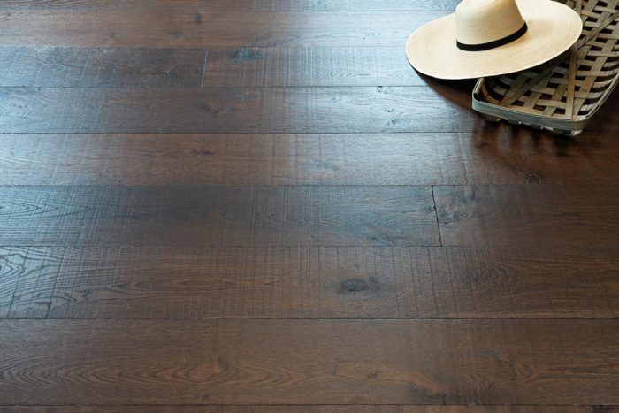 close up of hardwood floor with white, large brimmed hat