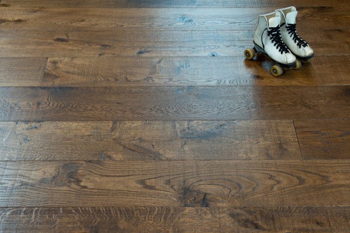 close up of hardwood floor with white rollerskates