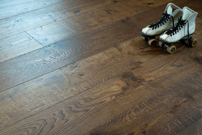 close up of hardwood floor with white rollerskates