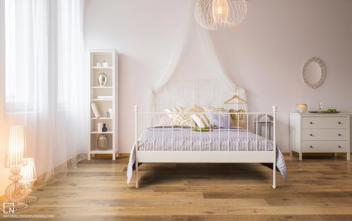 hardwood floor in white furnished bedroom with bed, bookcase, and drawers