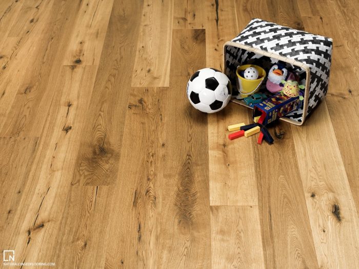 hardwood floor with black and white basket filled with kids toys