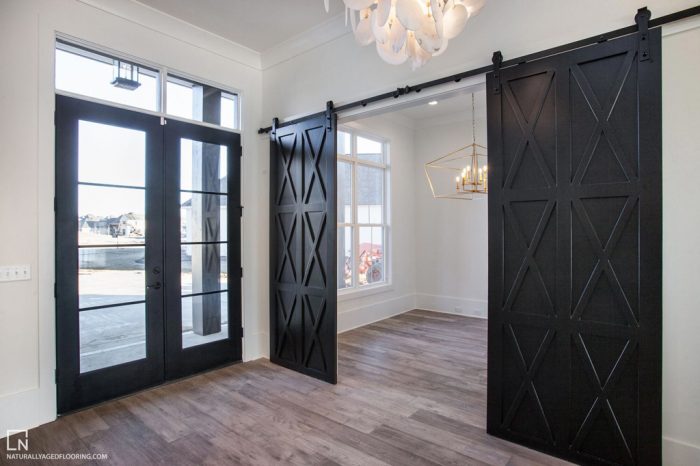 hardwood floors in two rooms with black doors