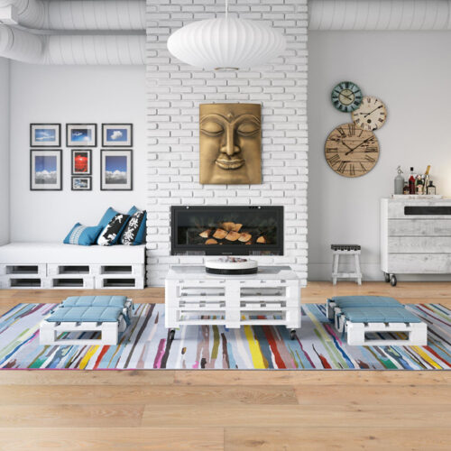 hardwood floor in informal sitting room with table, low benches, fireplace, and artwork