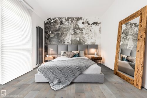 hardwood floor in gray bedroom with bed, large mirror and window