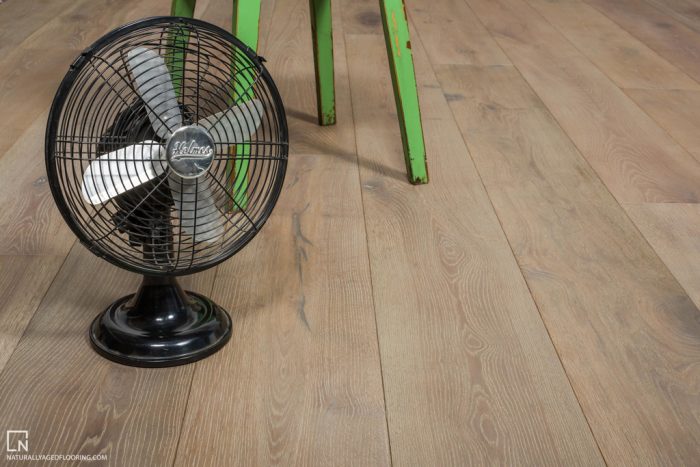 hardwood floor with green table, and table fan on floor
