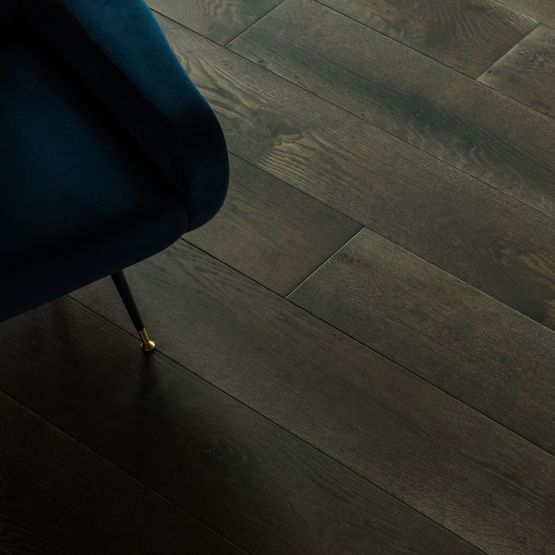 overhead view of hardwood flooring and part of a chair in the corner of the picture