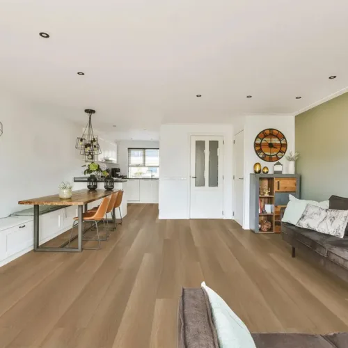 Burlington warm medium-brown waterproof luxury vinyl plank flooring in a modern open-plan living and dining room