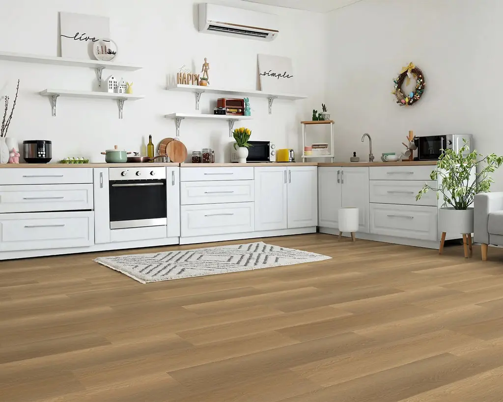 Weston warm golden-tan waterproof luxury vinyl plank flooring in a sleek modern kitchen with white cabinets